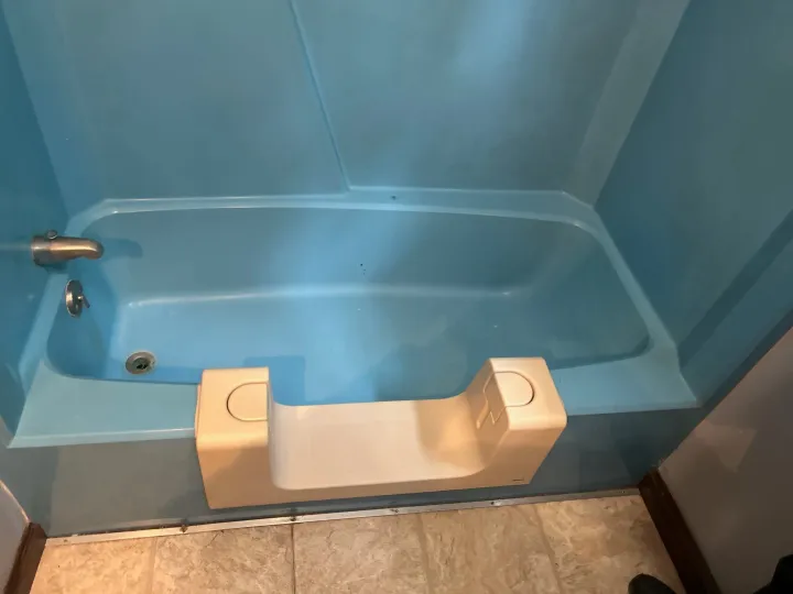 Blue bathtub and surround before reglazing